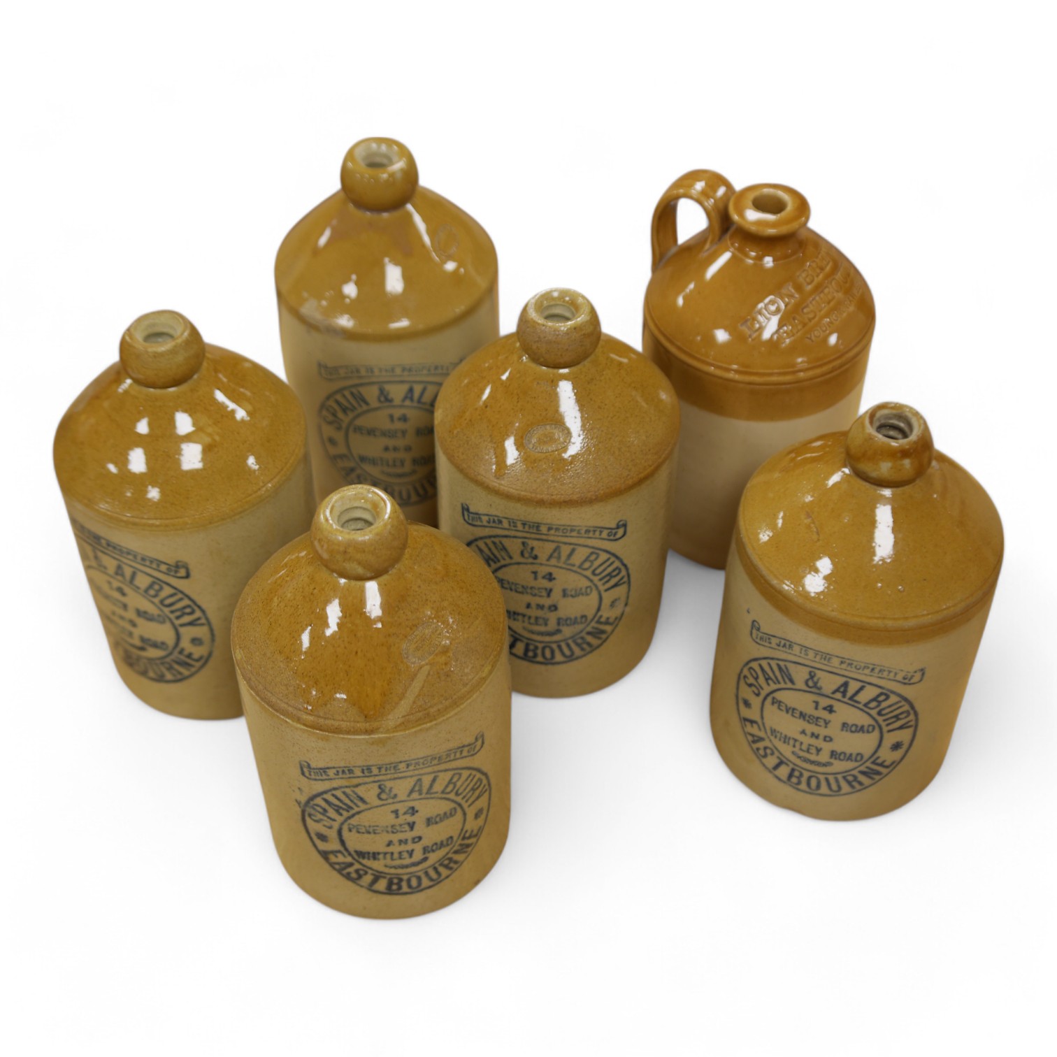 A set of five 'Spain & Albury, Eastbourne' earthenware flagons and another 'Lion Brewery, Eastbourne, Young and Rawley', 26.5cm (6). Condition - fair to good